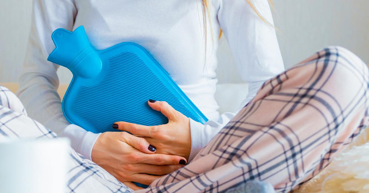 Woman with heating pad 1200x628 facebook